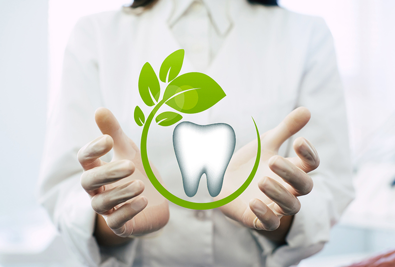 mani con simbolo di dente e foglia verde